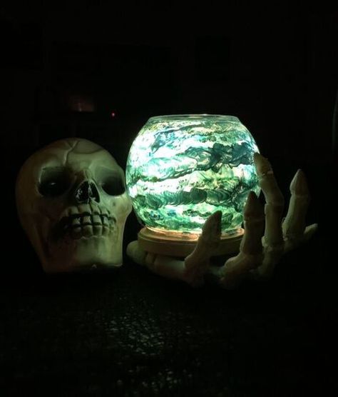 In this creative tutorial, you will learn to DIY a spooky crystal ball. Simple step-by-step instructions provided! Crystal Ball Pumpkin Carving, Hand Holding Crystal Ball, Hand Holding Crystal, Skeleton Hand Holding, Skeleton Finger, Plastic Skeleton, Gold Acrylic Paint, Creative Tutorials, Blue Food Coloring