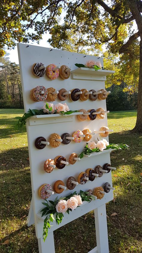 Self standing donut wall with 3 shelves for flowers, signs or more donuts! #donutwall #dessertstation #niagaraweddings #niagarawedding #weddingideas #niagaraweddingdecor #weddingrentals #desserts #foodbars #funfoods Shelves For Flowers, Beverage Bars, Dessert Boards, Donut Display, Cupcake Holders, Champagne Wall, Niagara Wedding, Dessert Station, Donut Wall