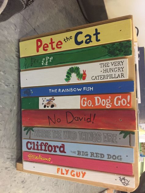 Side of bookcase for my classroom. Hand painted to look like children's book spines. Classroom Bookcase Ideas, Read Sign For Classroom Diy, Story Book Theme Classroom, Painted Book Spines, Book Spine Painting, Spine Painting, Book Mural, Brick Books, Library Mural