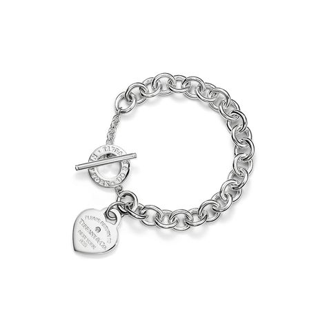 Inspired by a key ring we debuted in 1969, the Return to Tiffany® collection is famous for its signature motif. This sterling silver link bracelet features the iconic heart tag set with a round brilliant diamond and an oversized toggle closure. It’s a standout when worn on its own and also combines beautifully with your favorite stack of bracelets. Sterling silver with a round brilliant diamond; Size extra small; 6.97’’ long; Motif size, medium; Toggle closure; Carat weight .02 | Return to Tiffany® Heart Tag Bracelet in Silver with a Diamond, Medium, Size: Extra Small Tiffany Silver Bracelet, Tiffany Chain Bracelet, Tiffany Bracelet Aesthetic, Tiffany Bracelet Stack, Tiffany And Co Aesthetic, Tiffany Charm Bracelets, Return To Tiffany Bracelet, Tiffany Charm Bracelet, Bridal Jewelry Bracelets