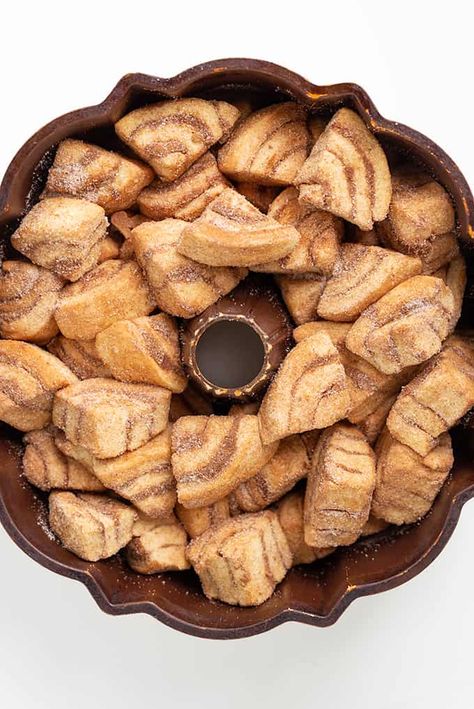 Easy Cinnamon Roll Monkey Bread - This easy pull-apart Cinnamon Roll Monkey Bread is made with canned cinnamon rolls and coated in a cinnamon and sugar mixture. This monkey bread makes the perfect holiday breakfast or just a treat for the family to pick at any time of the day! #cookiedoughandovenmitt Monkey Bread With Croissant Dough, Easy Pull Apart Monkey Bread, Monkey Bread Made With Cinnamon Rolls, Cinnamon Roll Bundt Cake Monkey Bread, Cinnamon Roll Monkey Bread Easy, Easy Monkey Bread Cinnamon Rolls, Pull Apart Cinnamon Rolls Monkey Bread, Monkey Bread Crescent Rolls, Canned Cinnamon Roll Monkey Bread