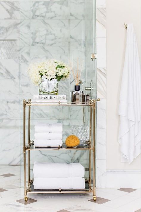 A refined gold and glass rolling cart is a gorgeous option for a sophisticated and chic bathroom Chic Bathroom, Smart Bathroom, Rolling Cart, Chic Bathrooms, Stylish Bathroom, Tub Faucet, Brass Lighting, Beautiful Backdrops, Bathroom Shelves