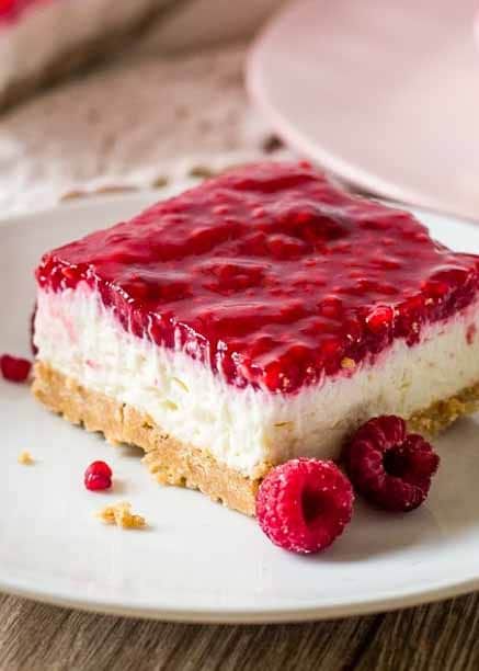 These No Bake Raspberry Cheesecake Squares have a graham cracker crust, a creamy no bake cheesecake filling and a homemade raspberry layer on top. Raspberry Cheesecake No Bake, No Bake Raspberry Cheesecake Recipes, Raspberry Donut Cheesecake, No Bake Raspberry Cheesecake Bars, No Bake Cheesecake With Raspberry Sauce, Lemon Raspberry Cheesecake No Bake, Cheesecake Without Graham Cracker Crust, Baked Graham Cracker Crust, Raspberry Pie Filling