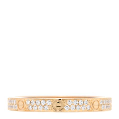 This is an authentic CARTIER 18K Yellow Gold Diamond 2.6mm LOVE Paved Band Ring. The ring is crafted of 18 karat yellow gold and features pave-set round brilliant cut diamonds, approximately .19 total carat weight, along the signature nail motifs.