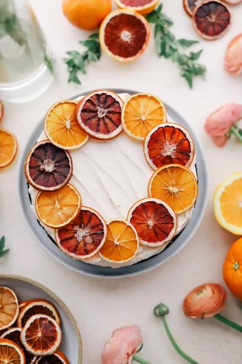 Overhead shot of orange cake with spring decor. Orange And Chocolate Cake, Dried Orange Cake, Cake With Orange Slices, Orange Cake Design, Orange Chocolate Cake Recipe, Orange Blossom Cake, Orange Cake Decoration, Orange Slice Cake, Orange Buttercream Frosting