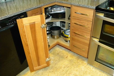 We used to have a blind corner here and it was mostly useless. The new hinged door gave us a nice, wide opening to the cabinet. And we went with shelves instead of a Lazy Susan to store pots and pans. My husband added some dividers to make the most efficient use of the space. He even built-in a little area to store the lids for the pots. Kitchen Organization Pots And Pans, Diy Blind Corner Cabinet Solution, Organization Pots And Pans, Blind Corner Top Cabinet Solutions, Blind Corner Cabinet Solutions Diy Kitchen Storage, Blind Corner Cupboard Storage Solutions, Corner Cabinet Door Hinge, Best Paint For Kitchen, Blind Corner Cabinet