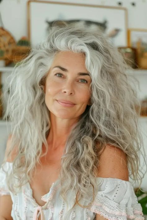 Woman with long, curly, gray hair smiling softly at the camera. Gray Curly Hair Natural Curls, Curly Grey Hair Natural Curls, Salt And Pepper Hairstyles, Curly Gray Hair Over 50, Grey Hair Women, Gray Curls, Curly Haircuts For Women, Lob Styles, Haircut Options