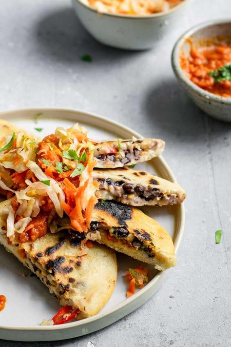 These homemade pupusas are a delicious traditional Salvadoran dish. Served with a cabbage relish and red salsa, and are vegan and gluten free. Black Bean Pupusas, Papusa Recipe Vegan, Tofu Queso, Vegan Pupusas, Homemade Pupusas, Salvadoran Pupusas, Pupusa Recipe, Traditional Spanish Recipes, Fermented Cabbage