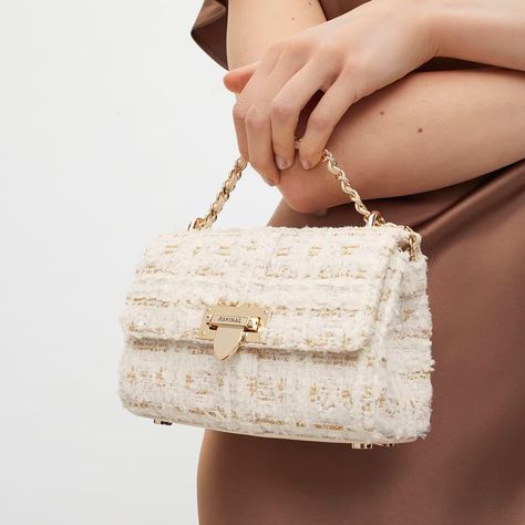 Miniature in size but mighty on style, our Micro Lottie Crossbody Bag in ivory tweed is designed to carry your barest of essentials. Handcrafted from full-grain leather, sophisticated tweed weaves together ivory and gold threads for a rich finish that brings a luxurious edge to any outfit ensemble.* Our best-selling silhouette in positively micro proportions boasts all the beautifully eye-catching detailing of the original, including our iconic letterbox closure and leather plaited metal chain. Tweed Bag Outfit, Tweed Handbag, Tweed Outfit, Tweed Bag, London Bags, Aspinal Of London, Signature Hardware, Money Bag, Kirigami