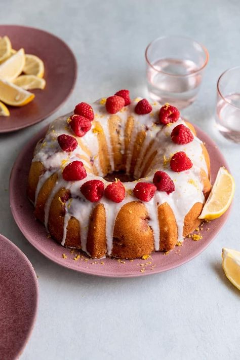 This Lemon Raspberry bundt cake is made with fresh (or frozen) raspberries and lemon. The cake is moist and fluffy and bursting with lemon flavor. It's topped with a light glaze and garnished with raspberries and lemon zest. It feeds 12 people and is the perfect summertime cake! #lemonraspberrybundtcake #lemonbundtcake #lemonandraspberrycake #bundtcake #frostingandfettuccine Lemon Raspberry Bundt Cake, Raspberry Bundt Cake, Lemon Raspberry Cake, Orange Bundt Cake, Frozen Raspberries, Lemon Bundt Cake, Raspberry Cake, Lemon Flavor, Lemon Raspberry