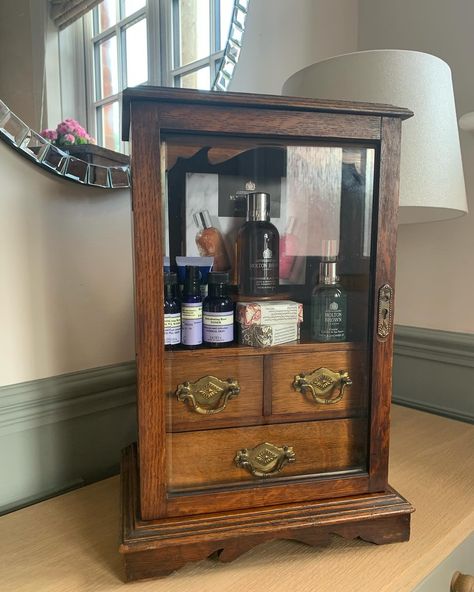 We are all about repurposing beautiful old items. It’s days as a Smoking Cabinet are probably over but don’t you think this gorgeous oak, smokers cabinet makes a wonderful bathroom cabinet, three little drawers to put bits and pieces in and a shelf to display your favourite soaps etc on, behind a beautiful bevelled edge glass door - so much nicer than a modern cabinet, would look charming in a cottage bathroom. #smokerscaninet #reloved #repurposed #oldoak #bathroomcabinet #vintagefinds #anti... Apothecary Wall, Modern Cabinet, Cottage Bathroom, Molton Brown, Modern Cabinets, Cabinet Making, Bits And Pieces, Bathroom Cabinet, Vintage Garden