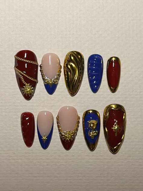 red and blue, gold chrome, gold chain, 3d design nails Blue Gold Chrome Nails, Dark Red And Gold Nails Acrylic, Red Blue And Gold Nails, Blue Red Nails Art Designs, Nails Ideas Red And Gold, Red Blue Gold Nails, Red Nails With Gold Charms, Red And Blue Nail Designs, Gold Chain Nails