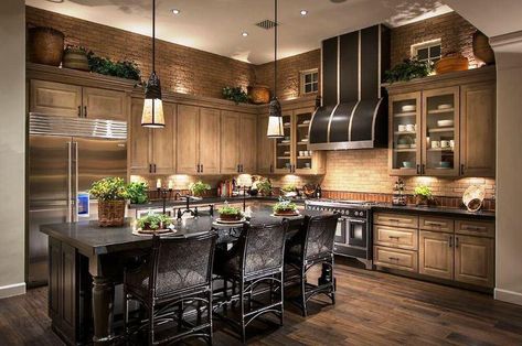 A warm and cozy kitchen with dark tones and mellow lighting along with accents of greenery! Cheap Backsplash, Brown Kitchen Cabinets, Dark Wood Kitchens, Black Island, Kitchen Styles, Brown Cabinets, Brown Kitchen, Dream Kitchens Design, Black Kitchen Cabinets