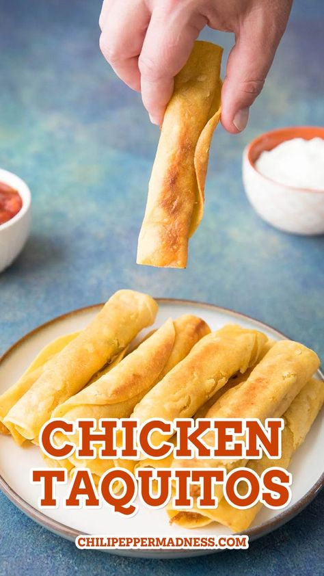 Holding one of the chicken taquitos over a stack of more taquitos. Rolled Tacos Recipe, Stuffed Tacos, Easy Chicken Taquitos, Chicken Taquitos Baked, Taquitos Baked, Rolled Chicken Tacos, Seasoned Shredded Chicken, Chicken Tortilla Wraps, Chicken Taquitos Recipe