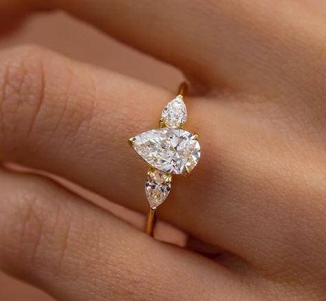 2.31 TC Pear Three Stone Ring, 14k Solid Yellow Gold Ring, Pear Cut Trilogy, Flawless Pear Solitaire Ring, 14k Engagement Ring, Gift For Her ❤ ITEM DETAILS:- ✦ Brand: The American Gold House (TAGH) ✦ Handmade, high-quality item! ✦ Material: Solid 10K/14K/18K Gold, 950 Platinum and 925 Sterling Silver ✦ Diamonds Type: Moissanite Diamond ✦ Diamond Color: Colorless ✦ Diamond Cut: 10x6 MM Pear ✦ Width of Band: 1.6 MM (Bottom) ✦ Diamond Clarity: VVS/VS ✦ Center Diamond: 10x6 Mm 1.71 CT Pear Cut ❤ SIDE STONE:- ✦ 2 X 0.30 Ct Pear Cut ------------------------------------------------------------------------------ 💎 Moissanite VS Diamond 💎 ------------------------------------------------------------------------------ 👉 Moissanite Maintain Their Clarity & Sparkle Throughout A Lifetime Just Like A Gold House, Pear Cut Ring, Ring Three Stone, Ring Gifts, Teardrop Ring, Pear Engagement Ring, Three Stone Ring, Colorless Diamond, Diamond Anniversary Rings