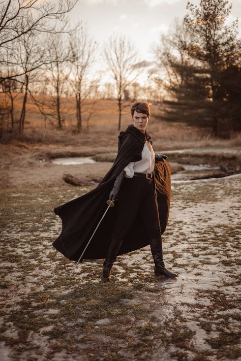 "Join the FOTW Realm and get an instant 10% off code! http://eepurl.com/hrobtv Give your costume flair with one of our linen hooded Ranger cloaks! These full flowing long capes are made with high quality 100% linen - giving them a very historical look & feel. Features a large pointy hood, full draping curved shoulders & a strong adjustable leather tie at the neck. ~ Adult one-size-fits all ~ Length approx. 50\" Credit: picture #1-2 by @theladynerd& @lizabetroberts, picture 3 by @theswordandthese Duo With Swords Pose, Person Wearing Cloak, Flowing Cape Drawing Reference, Cape Pose Reference, Cloak Poses, Cloak Photoshoot, Medieval Traveler, Wedding Armor, Cloak Aesthetic