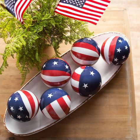 Add a patriotic look to home decor or other decorative pieces with these stars and stripes orbs. A great addition to Fourth of July decorations, these orbs look great in buckets, pails or any other container that needs a boost of patriotism. Display these orbs on the Fourth of July or any other patriotic holiday - or anytime of year when you want to show off your pride in the USA! Foam. (6 pcs. per unit) 3 1/2" diam. Patriotic Decorations Diy, 4th Of July Tiered Tray Decor, Decorative Orbs, Bucket Decor, Patriotic Tiered Tray Decor, Military Christmas, July Desserts, Blue Centerpieces, Indoor Holiday Decor