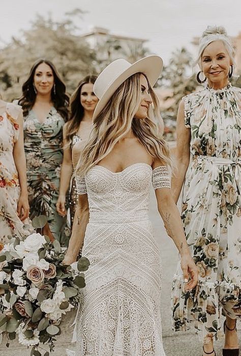 More prints, please! 🌸 Real bride Natalie's bride BABES wore a mix of floral patterns that perfectly complemented the lace of her Rue De Seine 'Ash' gown from Lovely Bride LA. Photo: By Amy Lynn | boho wedding dress, wedding dress with arm bands, crochet wedding dress #lovelybride #weddingdress Bride Hat Boho, Boho Wedding Hats For Bride, Boho Wedding Hat, Wedding Hats For Bride, Wedding Dress With Hat, Bride With Hat, Crochet Wedding Dress, White Bohemian Dress, 70s Wedding