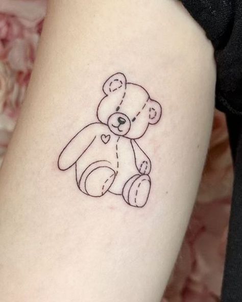 Discover the power of symbolism of bear tattoos. From realistic to minimalist designs, get your perfect bear tattoo inspiration. Lil Bear Tattoo, Teddy Bear Memorial Tattoo, Teddy Bear Line Tattoo, Bear Fine Line Tattoo, Fine Line Teddy Bear Tattoo, Simple Teddy Bear Tattoo, Teddy Bear Outline Tattoo, Teddy Bear Tattoo Ideas For Women, Tedy Tattoo