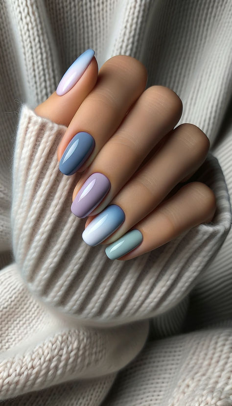 Capturing the essence of a serene winter morning, this nail art beautifully blends pastel shades of blue, lavender, and gray. The soft gradient on each nail mimics the tranquil hues of a wintery sky at dawn. Paired against the backdrop of a cozy knitted sweater, this mani effortlessly combines warmth and elegance, making it perfect for both relaxed weekends and stylish outings. A sophisticated way to embrace winter's gentle colors. 🌫️💅 #CozyPastelPalette #WinterElegance Nail Art Blue Pastel, Lavender Blue Nails, Sky Blue Gel Nails, Lavender Gel Nails, Blue Gray Nails, Pastel Color Nails, Nail Color Combinations, Bright Nail Art, Nails Styles