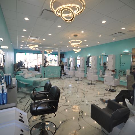 The construction process of this new hair salon started with the removal of the old store. All new plumbing, electric and insulation were installed before new sheet rock and drop ceilings. New ornate lighting system, with high hats and a chandeliers were installed. The walls were painted with a happy blue teal color to create a pleasant atmosphere. The floors were installed with the newest epoxy floor technology, creating a one-piece marble look imitating black veins in a real white marble floor Hair Salon Lighting Ideas Ceilings, Salon Lighting Ideas Ceiling, Salon Chandelier Ideas, Blue Hair Salon, Salon Lighting Ideas, White Hair Salon, Salon Suite Decor, Drop Ceilings, Salon Lighting