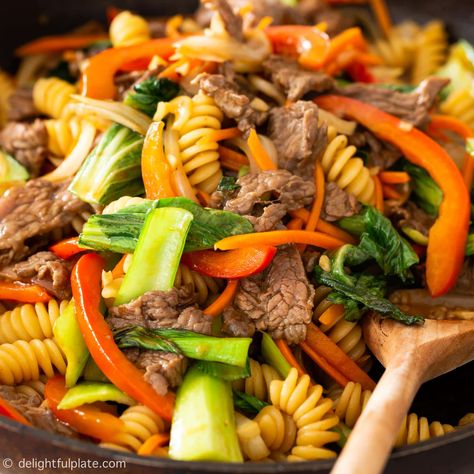 Vietnamese Beef Pasta Stir-Fry (Nui Xao Bo) is composed of pasta, beef and your choice of vegetables, all coated with a tasty savory sauce. This quick and easy stir-fried pasta is great for any meals of the day. Vietnamese Stir Fry, Mi Xao, Pasta Beef, Noodle Bowls Recipes, Fried Pasta, Vietnamese Beef, Vietnamese Style, Garlic Fried Rice, Meals Of The Day