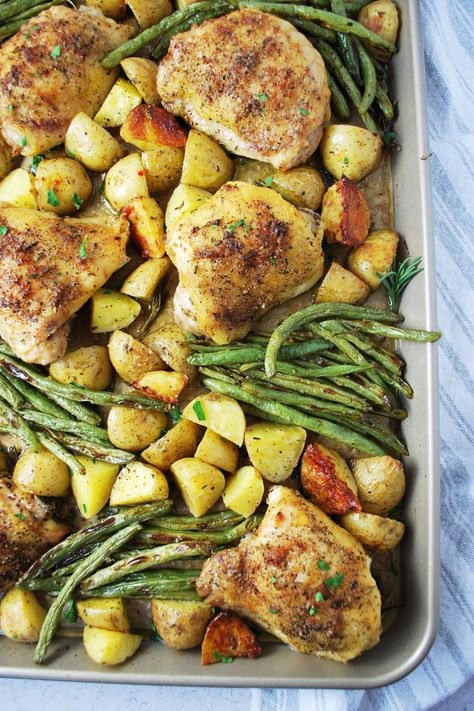 This Herb-Roasted Sheet Pan Chicken recipe made with chicken thighs, gold potatoes, and fresh green beans makes a delicious and easy weeknight meal.  This is a nutritious dinner that the whole family will devour! #sheetpanchicken #chickendinner #easychickenrecipe #chicken #onepanchicken Oven Chicken Potatoes Green Beans, Sheet Pan Chicken Green Beans Potatoes, Roasted Potatoes And Chicken In Oven, Chicken Thighs Potatoes, Sheet Pan Chicken Thighs, Pan Roasted Chicken, Chicken Breast Crockpot, Sheet Pan Meals Chicken, Chicken Breast Crockpot Recipes