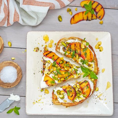 This ricotta toast recipe with grilled peaches is made with crunchy toasted sourdough bread, creamy whole milk ricotta cheese, grilled ripe peaches, crunchy pistachios, fresh mint and drizzled with peach glaze. Ricotta Toast Recipe with Ricotta And Peaches, Sweet Ricotta Toast, Fall Ricotta Toast, Peach And Ricotta Toast, Honey And Ricotta Toast, Ricotta Toast, Ricotta Recipes, Grilled Bread, Peach Slices