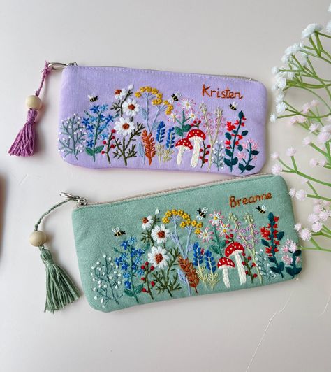 IF YOU NEED A PERSONALIZED DESIGN OR CUSTOM SIZE, PLEASE MESSAGE US. 📍 The pouch is embroidered with beautiful flowers, roses and can be customed your names, completely hand-embroidered from Vietnamese craftsmen.  - Material: soft linen combined with embroidery floss - Texture: embroidered flowers, mushroom and custom text.  - Size: 3.5x7.5" (9x19cm), 4.7x7.5" (12x19cm) The bag is not only pencil case but can be served as an everyday bag for your sunglasses, jewerly, coin purse. 📍  You buy thi Hand Embroidery Purse, Embroidery Bags Handmade, Linen Gifts, Embroidery Pouch, Hand Embroidered Gifts, Handmade Makeup Bag, Embroidery Purse, Linen Pouch, Denim Crafts Diy