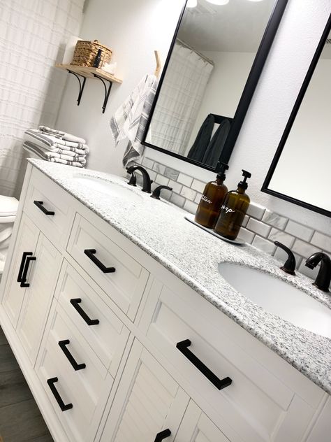 Charcoal And White Bathroom Ideas, Master Bath Black Hardware, Black And White Bathroom Countertops, White Double Sink Bathroom Vanity Black Hardware, White Cabinets Black Hardware Bathroom, White Bathroom Cabinets Black Hardware, Black And White Granite Bathroom, Granite Countertops With White Cabinets Bathroom, White Vanity With Black Hardware