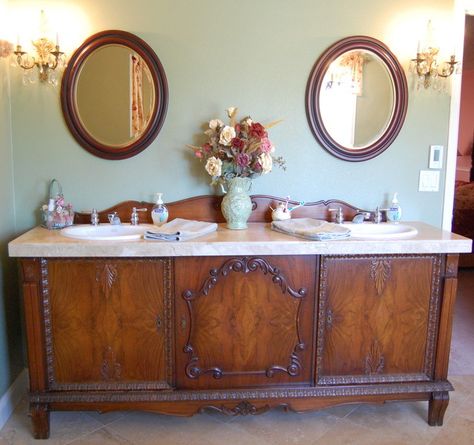 This buffet was purchased on Craigslist and fitted with a travertine top and a pair of white porcelain sinks. The original curved backplate ... Baie Vintage, Antique Sideboard Buffet, Baños Shabby Chic, Unique Bathroom Vanity, Vanity Makeover, Bathroom Vanity Designs, Antique Buffet, Diy Bathroom Vanity, Creative Bathroom