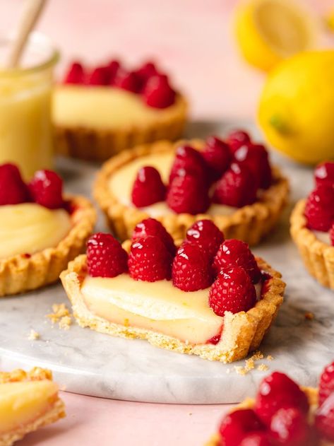 a cross-section of a mini lemon tart with glazed raspberries on top. Easy Lemon Tart, Easy Lemon Cake Recipe, Mini Lemon Tarts, Lemon Cake Mix Recipe, Lemon Tartlets, Mini Tart Recipes, Easy Tart Recipes, Lemon Yogurt Cake, Lemon Cake Easy