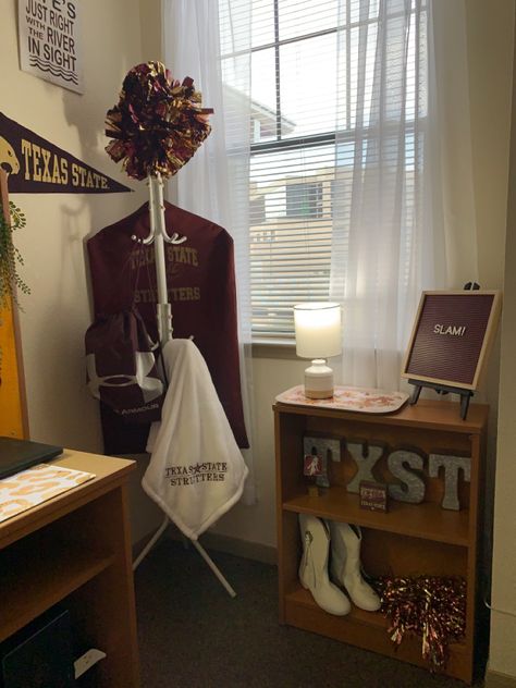 Tons of Texas State  University spirit in the space. Used a simple coat rack to organize Strutters uniform, poms, hat and daily practice items to keep organized and not use up valuable closet space. Displayed boots on the shelf because drill team boots are just -cute -and this gave easy access to items for practice and game days and kept the room tidy. And if you know TXST you know the River runs through it and is a huge part of the college and San Marcos beauty and culture. Southwest Boho, San Jacinto, Texas State, Dorm Decorations, Texas