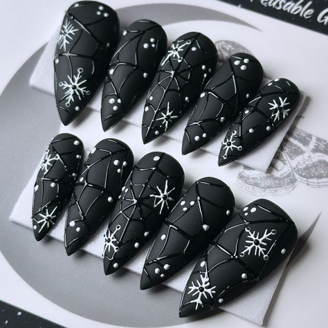 Gothic winter nails: where snowflakes meet spiderwebs, because even in the cold, we’re keeping it cool and spooky! ❄️🖤🕸️ Snowtrap, on Après Medium Stiletto 💅🏻 ⁣ .⁣ .⁣ .⁣ .⁣ .⁣ #gothnailsofinstagram #stayspooky #blacknails #halloweenforever #creepmas #gothicxmas #wintergoth #winternails #nailartist #gothicchristmas #spiderwebnails #spookychristmas #pressonnailset #seasonscreepings #gothvibes #gothicnails #gothmas #gothxmas #merrycreepmas #christmashalloween #gothstagram #gothstyle #gothchrist... Gothic Xmas Nails, Snowflake Nails Black, Goth New Years Nails, Gothic Winter Nails, White Goth Nails, Horror Christmas Nails, Gothmas Nails, Christmas Goth Nails, Grunge Christmas Nails