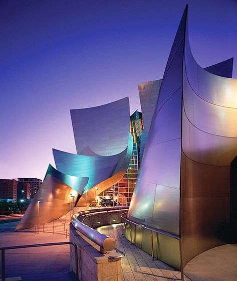 Walt Disney Concert Hall : Architecture : Built by Frank Gehry in Los Angeles 2003. Home to the LA Philharmonic it has received wide acclaim for its excellent acoustic and distinctive architecture. : The exterior is a composition of undulating and angles forms symbolizing musical movement and the motion of Los Angels. : The reflective stainless steel surface engages light as an architectural medium. The facadess individual panels and curves are articulated in daylight and colored by city lights