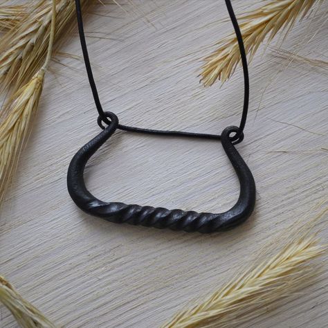 Drakar-is a long narrow wooden Viking boat with a highly broken bow and stern. Drakar is a symbol of help and protection in travel. Therefore, if you or your friends love to travel, this pendant will be a great gift for them. Made of iron, blued to prevent rust. Iron Necklace, Viking Boat, Hand Forged Jewelry, Broken Bow, Viking Pendant, Protection Amulet, Amulet Necklace, Friends Love, Hand Forged Iron