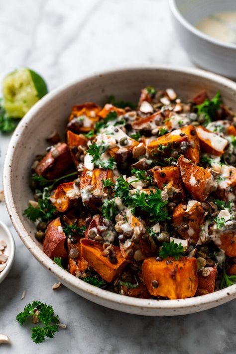 This warm roasted sweet potato lentil salad is a super simple quick sheet pan dinner tossed in a 2 minute roasted garlic tahini dressing, chopped almonds, and fresh parsley. A deliciously flavor-packed healthy meal or side dish that's full of plant protein and satiating fats to serve all week long! Potato Lentil Salad, Herbed Potato Salad, Vegan Protein Recipes, High Protein Vegan Recipes, Dried Lentils, Roasted Sweet Potato, Warm Salad, Salad With Sweet Potato, Lentil Salad