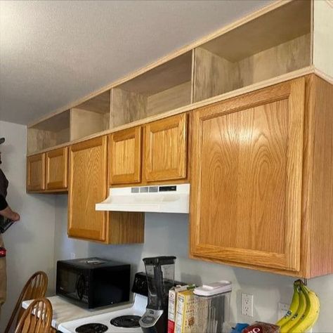 Wooden boxes built above the kitchen cabinets to extend cabinets up to the ceiling. Short Kitchen Cabinets, Storage Above Kitchen Cabinets, Extending Kitchen Cabinets, Affordable Kitchen Remodel, Kitchen Cabinets To The Ceiling, Above Kitchen Cabinets Ideas, Decorating Above Kitchen Cabinets Ideas, Above Cabinet Decor, Cabinets To The Ceiling