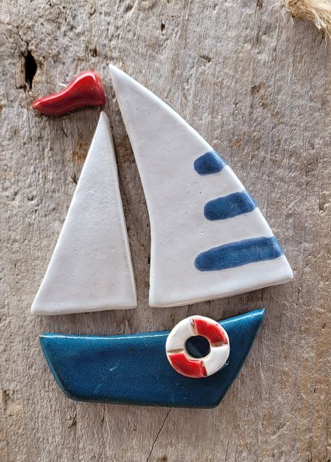 "Wall hanging plaque featuring a glazed stoneware boat in separate pieces, backed onto a piece of Dorset driftwood. Approx size 9\" x 5.5\" (23 x 14 cm) POSTAGE OVERSEAS. To keep postage costs as low as possible, smaller items will be posted via Royal Mail tracked which is not an express service and may take 2 - 3 weeks to arrive, please get in touch if you would like me to upgrade you to an express service (DPD) for a small extra charge. I post at cost so if the quoted postage paid is higher th Clay Boats Pottery, Ceramic Boat, Boat Wall Decor, Fondant Flower Tutorial, Ceramic Wall Hanging, Nautical Crafts, Ceramic Framed, Boat Wall, Fused Glass Artwork