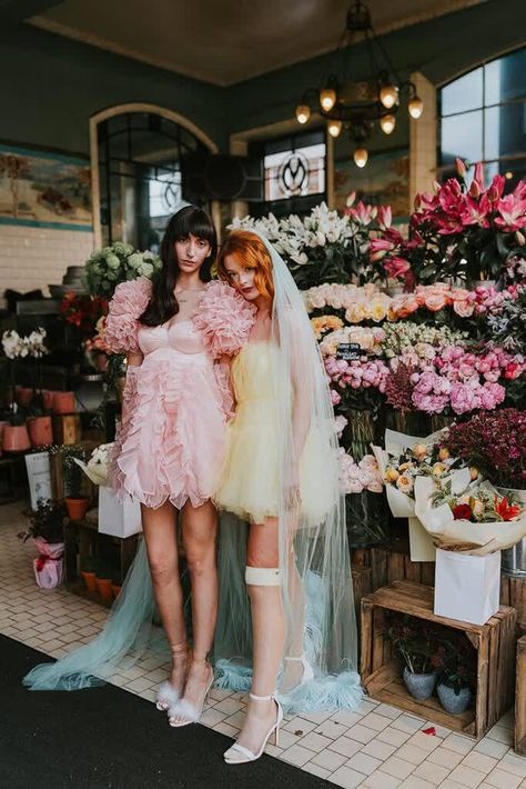 Female Wedding Couple In Short Pastel Wedding Dresses In Chelsea After Their Wedding at Chelsea Old Town Hall. One bride wears a short yellow wedding dress plus a blue feather veil and one bride wears a short pink wedding dress with a bridal cape. Colourful Wedding. Planning & Hair @bytiel Mini Pink Wedding Dress, Short Wedding Dress Color, Pastel Lace Dress, Short Pink Wedding Dress, Feather Veil, Pastel Wedding Dresses, Wlw Wedding, Town Hall Wedding, Pink Veil