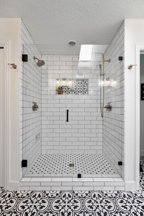 Tile walk-in shower with black and white tile Black And White Shower Floor Tile Ideas, White Subway Tile Bathroom Dark Grout, Modern Farmhouse Master Shower Ideas, Pattern Tile Shower Floor, White Tile With Dark Grout Bathroom, Walk In Shower White Subway Tile, Shower Tile Ideas Dark Grout, Black And White Shower Tile Ideas Farmhouse, Subway Tile Bathroom Shower Walk In