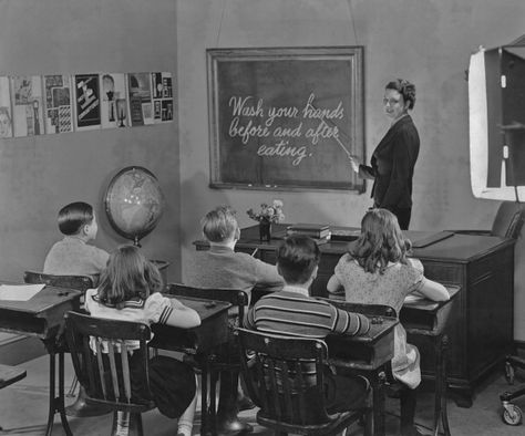 News Photo : A teacher pointing to a blackboard with 'Wash... Classroom Pictures, Leave It To Beaver, School Leadership, School Leader, Progress Report, Public Education, Vintage School, School Photos, A Christmas Story