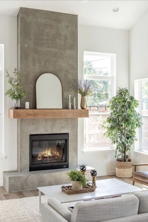 Looking for warmth without the clutter? Our blog post highlights chic electric fireplaces that fit perfectly into small spaces. They're not just practical—they're a style statement. Click to discover which model has the cozy factor you're after. Your snug retreat is just a read away. #GoTinySpace #ElectricFireplaces #CozyHome #InteriorDesign Living Room With Concrete Fireplace, Earthy Fireplace Decor, Cement And Wood Fireplace, Concrete Gas Fireplace, Neutral Fireplace Ideas, Concrete Fireplace With Wood Mantle, Sheetrock Fireplace, Concrete Look Fireplace, Fireplace No Chimney