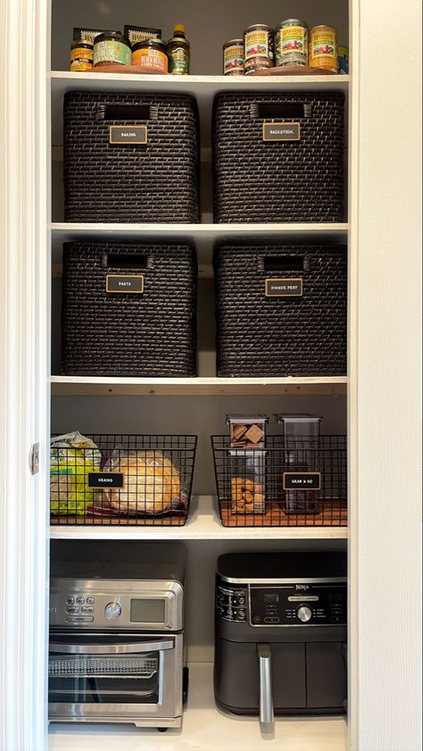 The tailored pantry trio - container store lazy susans, marie kondo wicker baskets, neat method acacia and black metal bins. Shout out to ninja air fryer and cuisinart toaster oven for a chic small appliance design. Kitchen Cabinet Baskets, Pantry Organization Appliances, Storing Appliances In Pantry, Black Pantry Organization, Pantry Basket Organization, Closet Pantry Organization, Open Shelf Pantry, Wicker Basket Diy, Cuisinart Toaster Oven