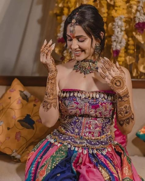 Swooning over Esha Kansara’s enchanting mehendi look! 🌟 Her vibrant multicolored lehenga paired with stunning jewelry creates pure magic. Swipe to be inspired by this mesmerizing style! 💚 . . Couple: Esha Kansara & Siddharth Amit Bhavsar⁠ Outfit by: @annu_patel1402 , annus_creation⁠ Jewellery: @aesha.desaii , @tamraa.bespokejewelry⁠ Mehndi: @jayshreebridalmehandi⁠ Photographer: @karmaproduction_india⁠ Hair: @_hair.by.freya_⁠ Makeup: @theglitterboxbyshreyapatel⁠ Event managed by: @anc_events ... Multicolored Lehenga, Esha Kansara, Mehendi Look, Simple Lehenga, Style Couple, Mehendi Outfits, Bride Pictures, Bridal Outfit, Wedding Entertainment