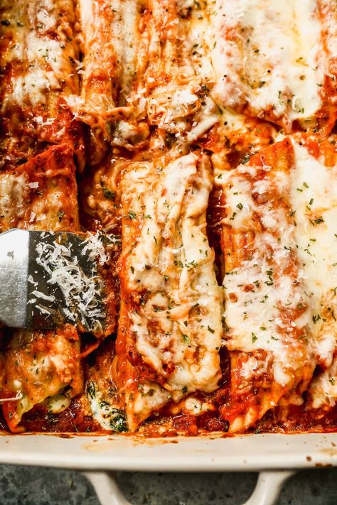 This easy stuffed manicotti recipe is filled with 3 cheeses and spinach, smothered in marinara and more cheese, then baked to perfection! Spinach Stuffed Manicotti, Stuffed Manicotti Recipe, Spinach Manicotti, Manicotti Recipe, Marinara, Spinach, Main Dishes, Cheese, Baking