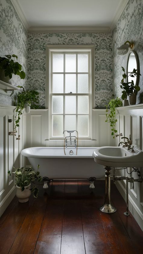 Discover a tranquil vintage bathroom with a clawfoot tub, floral wallpaper, and lush greenery. Perfect for relaxation and rejuvenation in your home. #BathroomDesign #VintageStyle Cottage Bathroom Clawfoot Tub, Small Clawfoot Tub Bathroom, Oak Floor Bathroom, Vintage Clawfoot Tub Bathroom, Small Bathroom Clawfoot Tub, Clawfoot Tub Bathroom Vintage, Clawfoot Tub Shower Combo, Small Bathroom With Clawfoot Tub, Bathrooms With Clawfoot Tubs