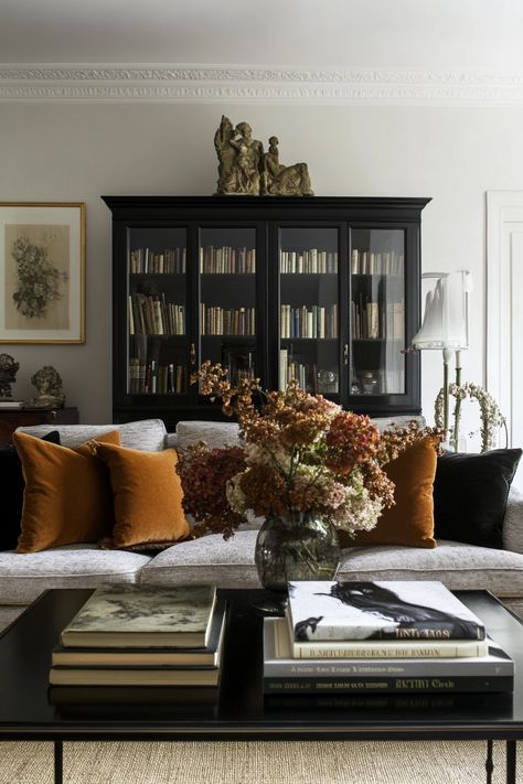 Top Of Living Room Cabinet Decor, Black In Living Room, Living Room Design With Brown Sofa, Rich Colored Living Room, Dark Cottagecore Living Room Cozy, Mid Century Modern Meets Traditional Living Room, Black Bookcases Living Room, Velvet Pillows Living Room, Box Living Room Ideas