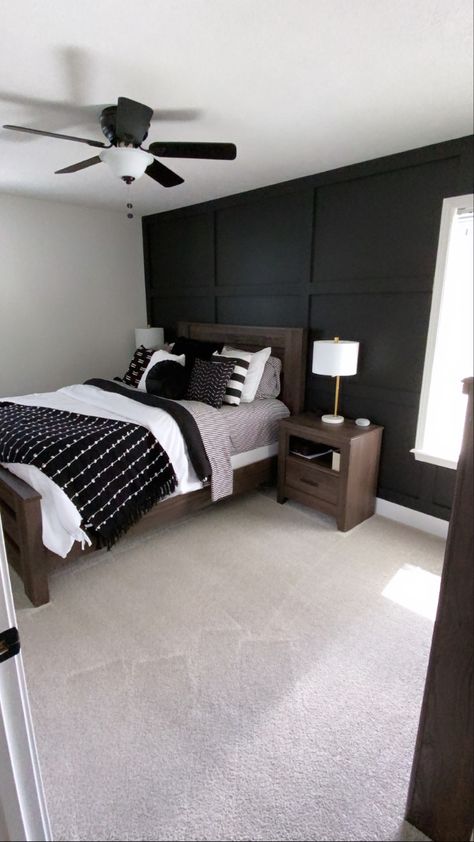 Black and white bedroom. Black board and batten accent wall. Black Accent Wall With Window Bedroom, Black Room With Accent Wall, Grey And Black Accent Wall, Dark Charcoal Accent Wall Bedroom, Black Wall Ideas Bedroom, Black Accent Wall Grey Bed, Beadboard Bedroom Ideas, Charcoal Wall Bedroom Ideas, Boys Bedroom Black Wall