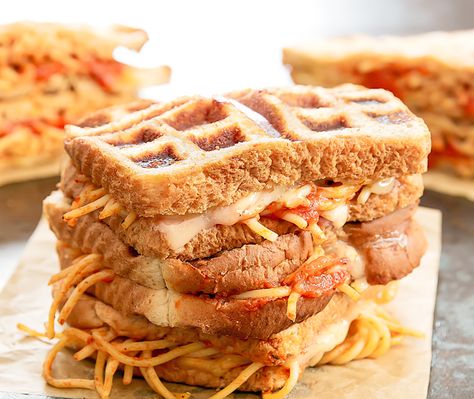 Spaghetti grilled cheese sandwiches. Spaghetti and cheese are sandwiched between bread slices and cooked in a waffle iron. Garlic Bread Spaghetti Waffle Sandwich, Spaghetti Grilled Cheese, Garlic Bread Spaghetti, Spaghetti And Cheese, Spaghetti Sandwich, Fall Sandwiches, Food Polls, Grilled Cheese Sandwiches, Waffle Sandwich